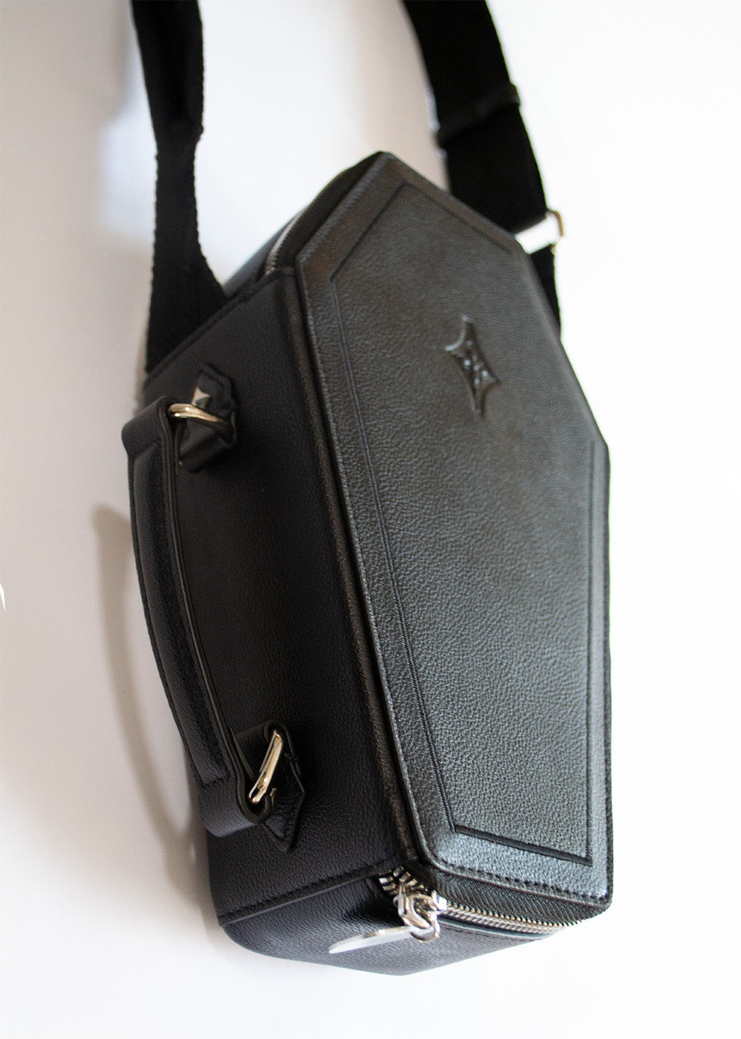 Mary and Shelley Casquette Crossbody coffin bag in black leather, shown with detachable guitar strap and silver zipper detail.