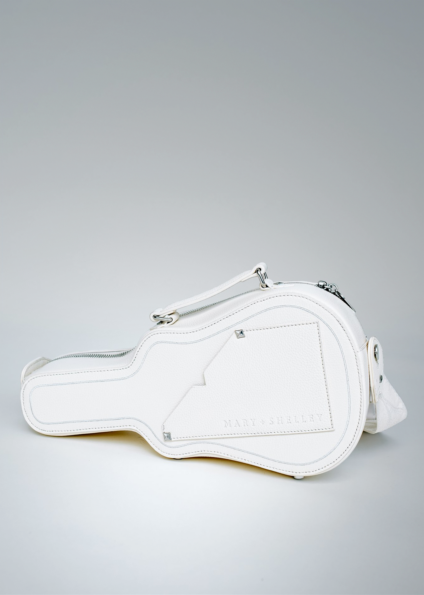 White (Ivory) Mary and Shelley Ritual Crossbody Bag with guitar case-inspired silhouette, silver hardware, and embossed logo.