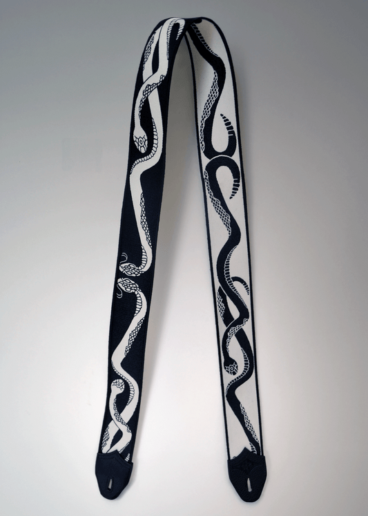 Reversible black and ivory snake jacquard guitar strap with black leather endcaps by Mary and Shelley