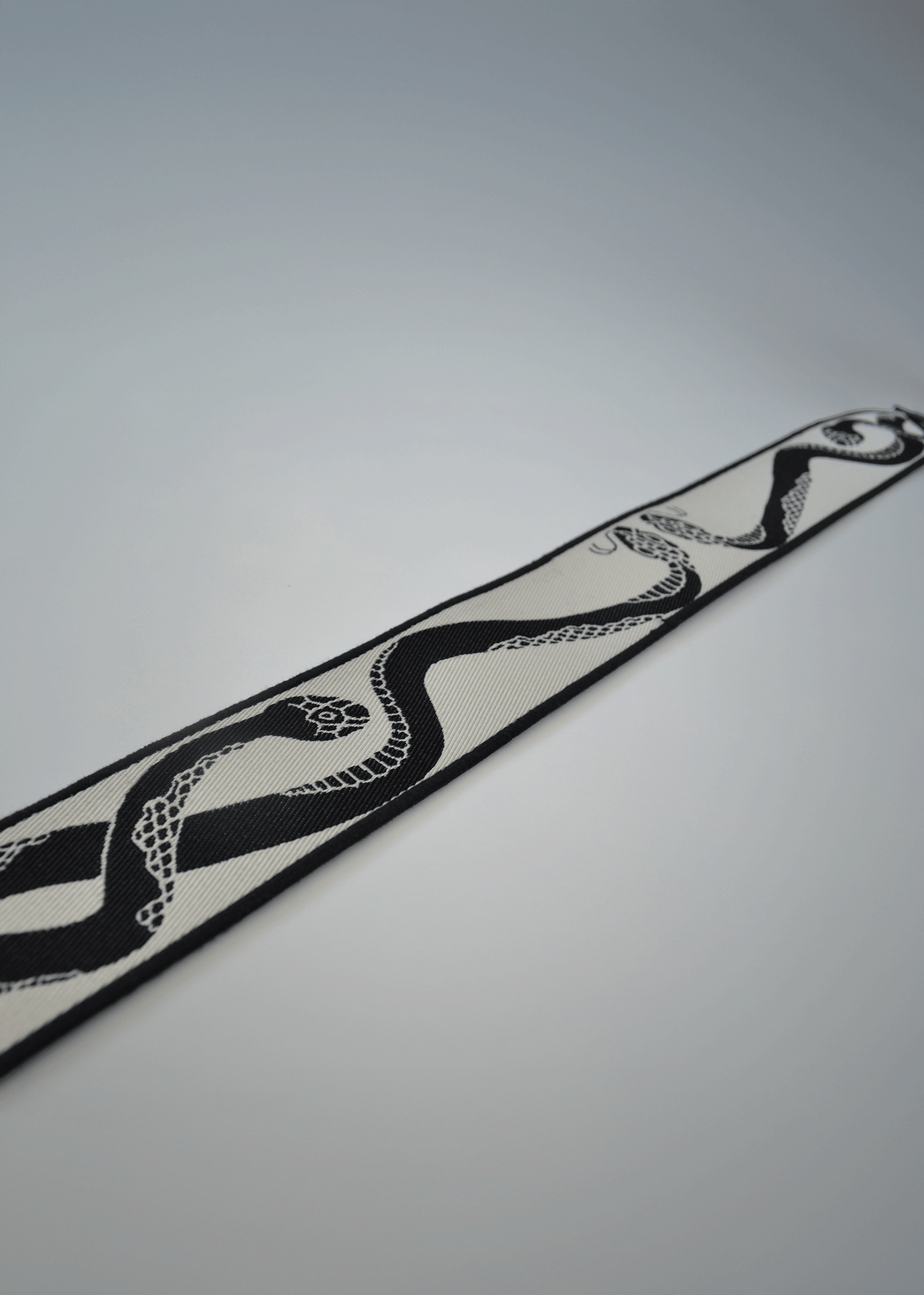 Ivory side of reversible snake jacquard guitar strap by Mary and Shelley, close-up detail.