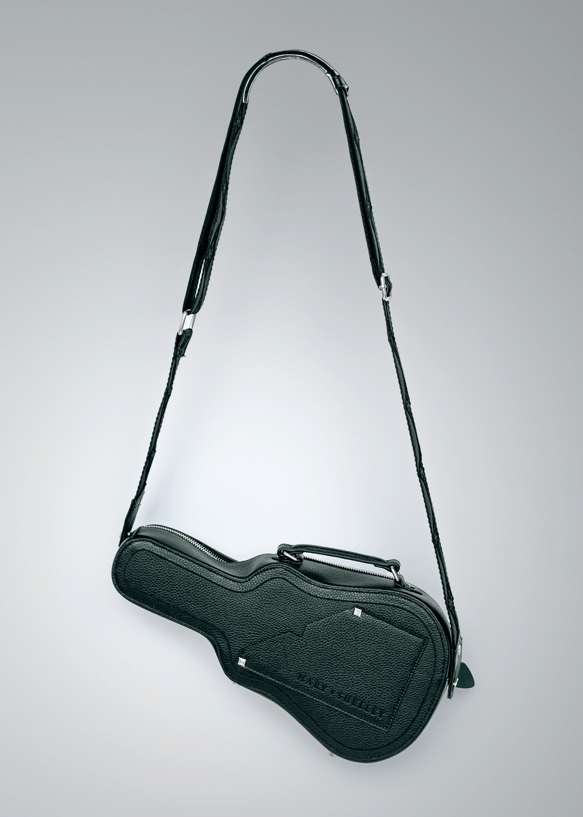 Black Mary and Shelley Ritual Crossbody Bag with guitar case silhouette, adjustable jacquard logo strap, and embossed logo detail.