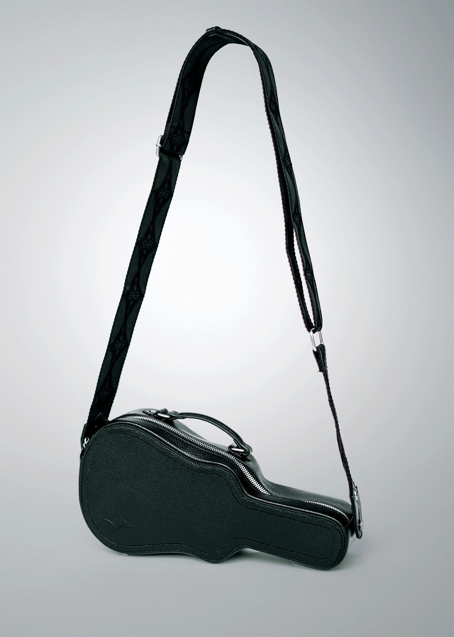 Black Mary and Shelley Ritual Crossbody Bag with guitar case silhouette and adjustable jacquard strap, shown hanging to display full shape.