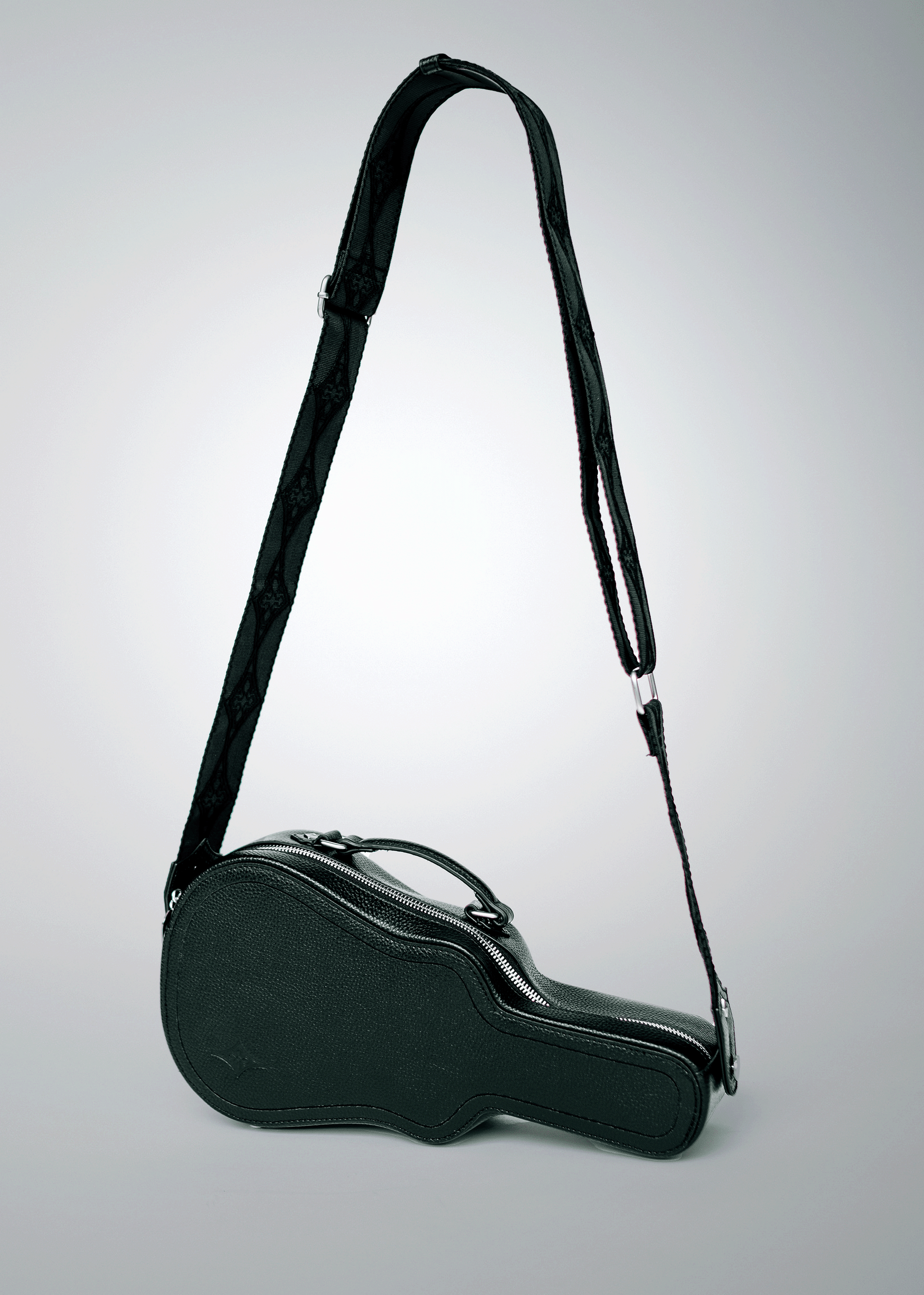 Black Mary and Shelley Ritual Crossbody Bag with guitar case silhouette and adjustable jacquard strap, shown hanging to display full shape.