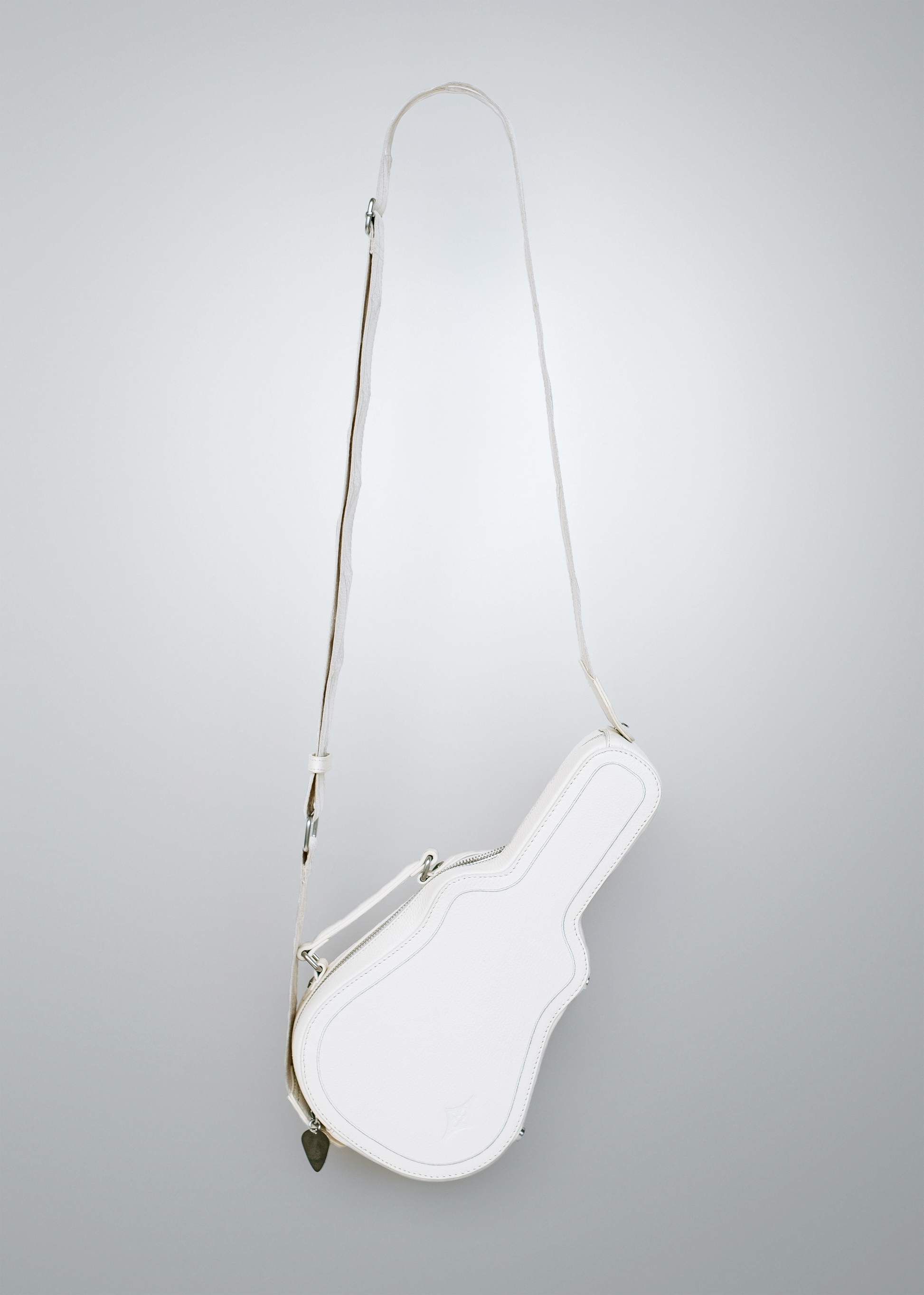 White Mary and Shelley Ritual Crossbody Bag with adjustable cotton jacquard strap, guitar pick zipper pull, shown fully extended to display guitar case silhouette.